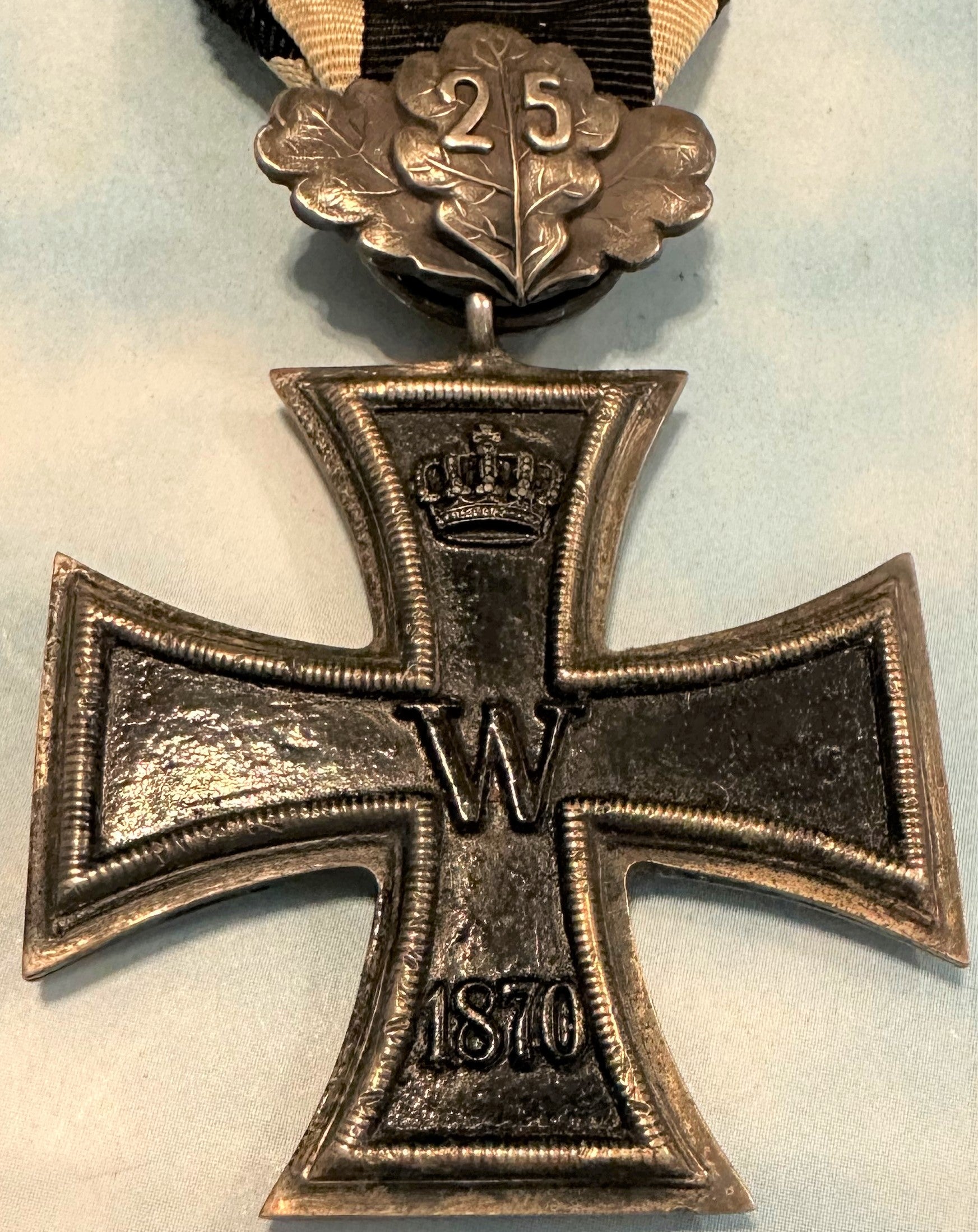 German 1870 Iron Cross 2nd class with 25 year oak leaves and 1914 Iron Cross 2nd class combination - Derrittmeister Militaria Group