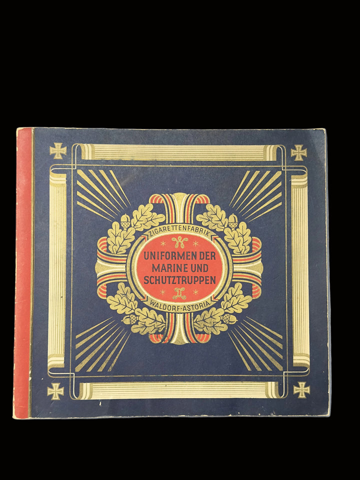 A vintage book or booklet titled 'Uniformen der Marine und Schutztruppen' by Hugo Feuchtwand, featuring a dark navy cover with gold decorative borders, a central red oval, and a laurel wreath illustration.