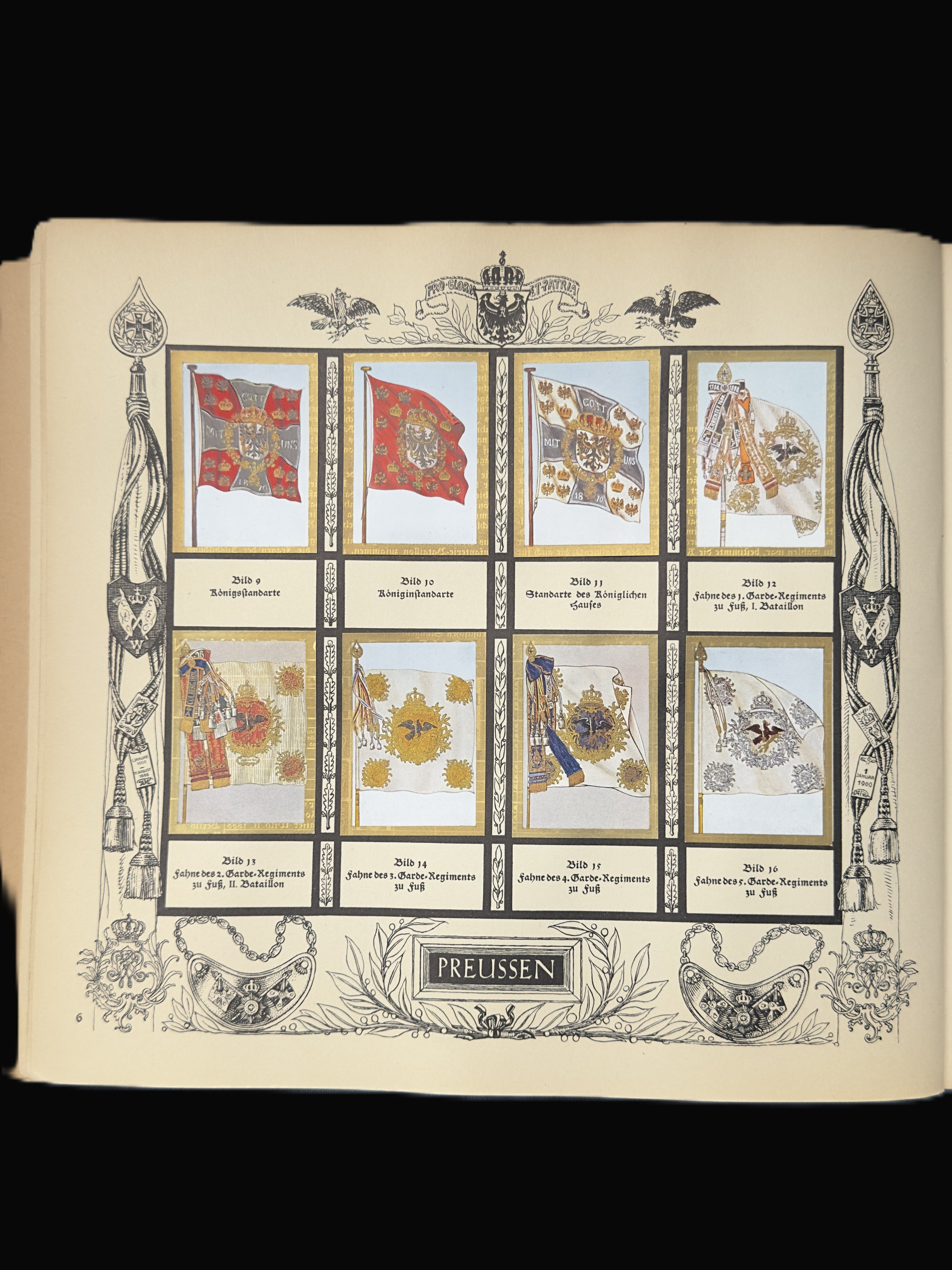 An open vintage book or album page showing a printed collection of eight military flag illustrations labeled in German, including Prussian and Russian flags, with ornate black line art and a central title panel reading 'PRETTSEN'.