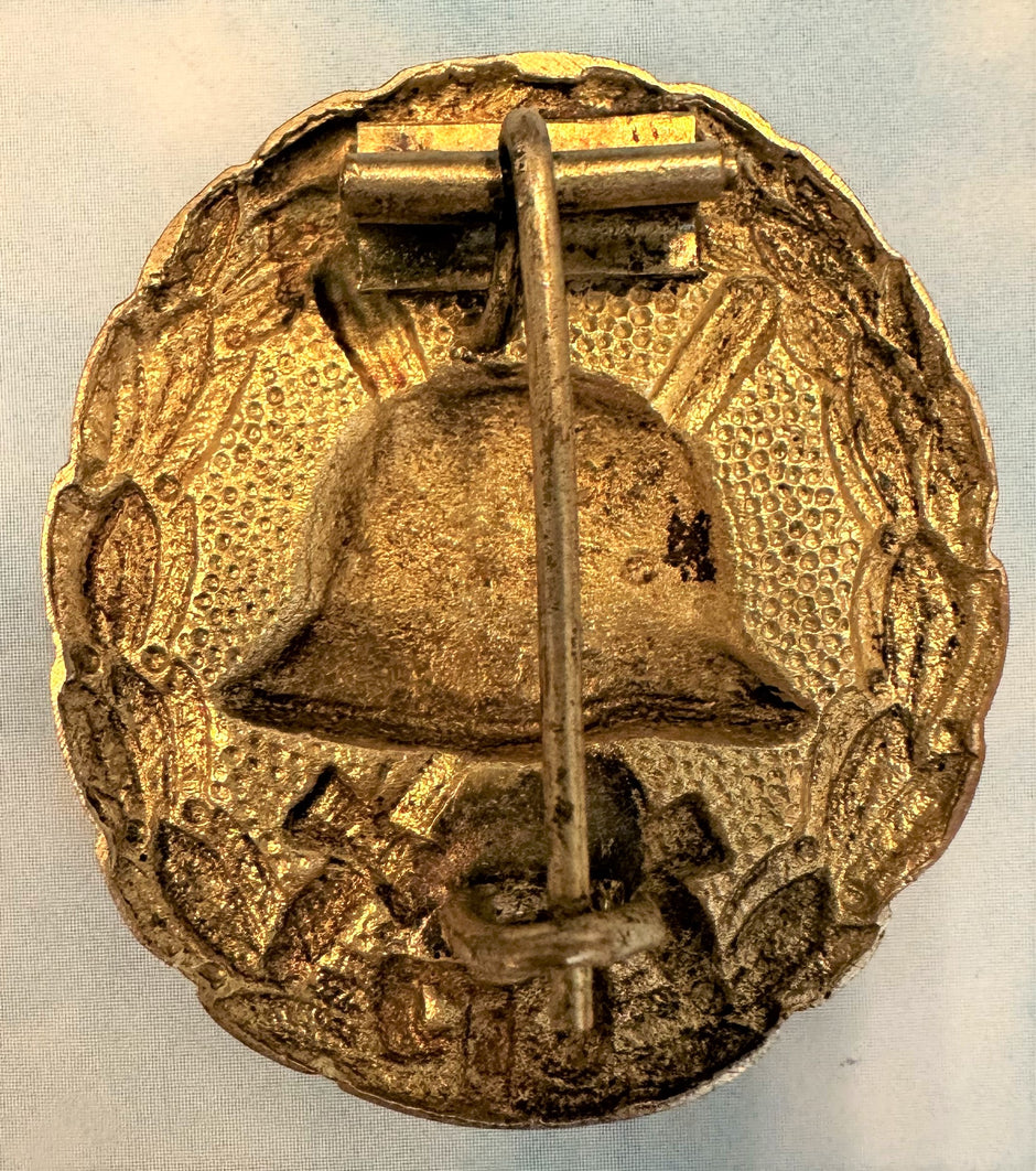 Lot - A Third Reich Gold Wound Badge (1st Class) & a WWI Black Version